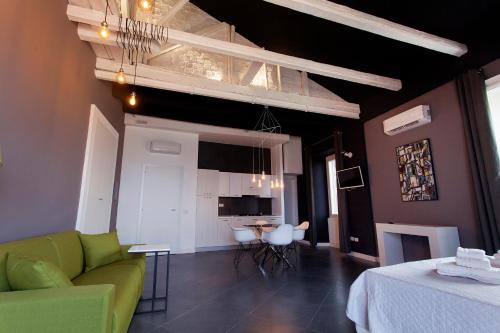 a living room with a green couch and a table at Residenza Nausicaa - 50 meters from the beach in Pizzo
