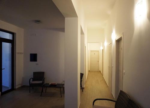 a room with a hallway with a table and chairs at Il Sogno di Calipso in Amendolara