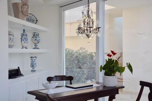 a dining room with a table and a chandelier at Sciccosa Guest House in Taormina