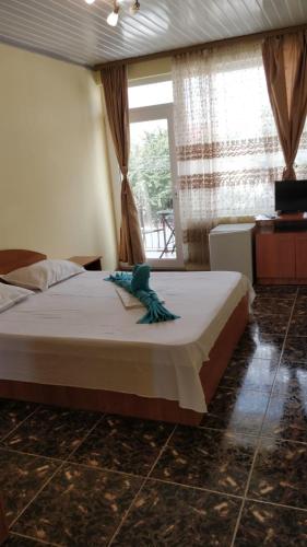 a bedroom with a large bed and a window at Casa Dora Costinești in Costinesti