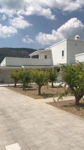 a large white building with trees in front of it at Agriturismo Giorgio in Mattinata
