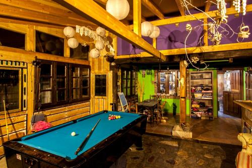 a pool table in a room with wooden walls at El Búho de la Remolina in Bode