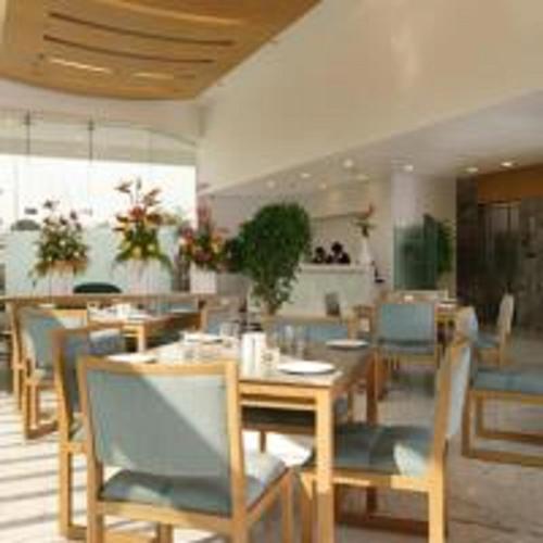 a dining room with tables and chairs in a restaurant at Yogi Executive, Navi Mumbai in Navi Mumbai