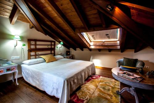 a bedroom with a large bed and a window at El Búho de la Remolina in Bode