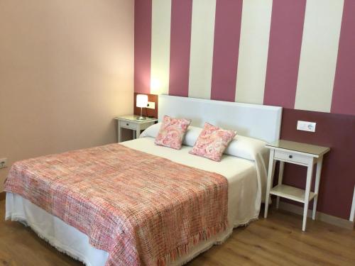 a hotel room with a bed with two pillows at Apartamento Ribadesella in Ribadesella
