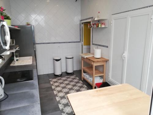 a kitchen with a sink and a table at Hostel Trotamundos in Seville
