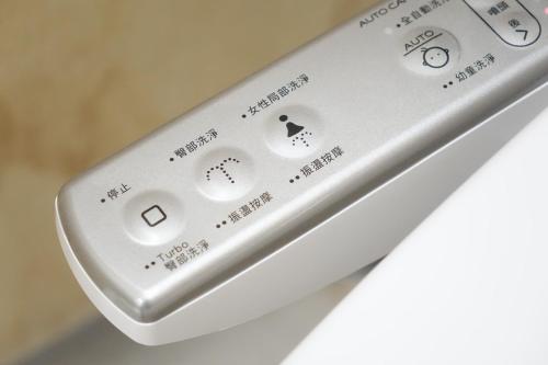 a close up of a remote control on a table at Cao Ji Book Inn Hostel in Tainan