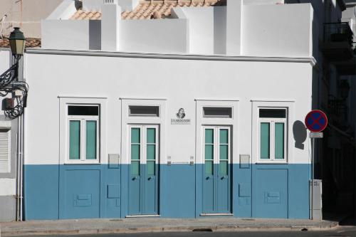 a building with blue doors on the side of it at DUBOCAGE43 Citycenter in Faro