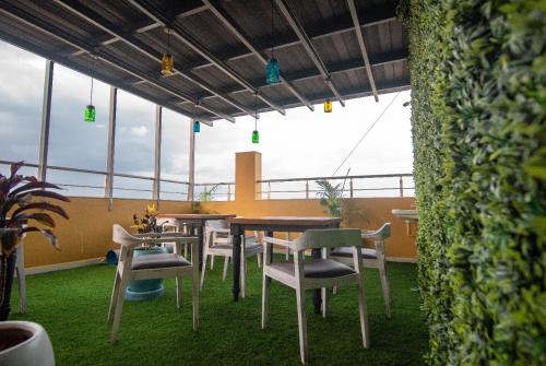 a restaurant with tables and chairs on a balcony at The Bull Boutique Hotel in Puducherry