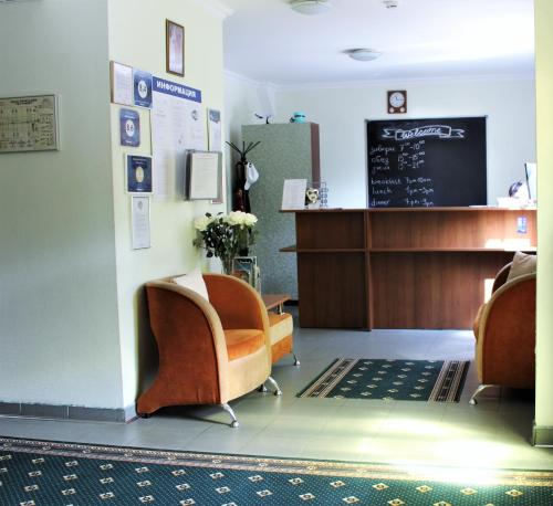 a waiting room with two chairs and a chalkboard at Hotel Vyrubovo in Odintsovo