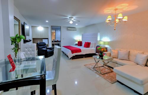 a living room with a bed and a couch at Hotel Boutique El Poblado in Neiva
