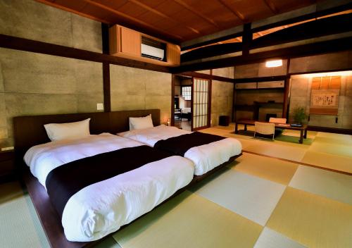 a bedroom with a large bed in a room at Temple-stay WAQOO Mii-dera in Otsu
