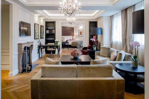 a living room with a couch and a fireplace at Hotel Schweizerhof Bern & Spa in Bern