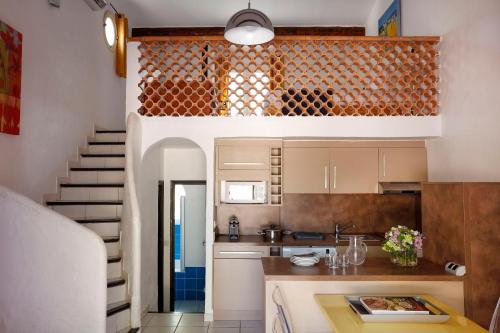a kitchen with a staircase leading up to a room at Résidence Vasca d'Oro in Porto-Vecchio