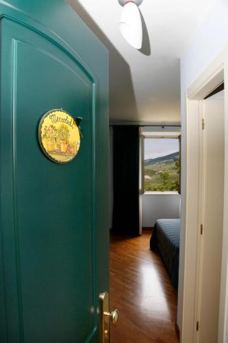 a room with a green door with a sign on it at Il Peschio in Pescocostanzo