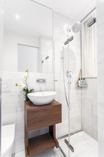 a bathroom with a sink and a shower at VISIONAPARTMENTS St Sulpice - contactless check-in in Lausanne