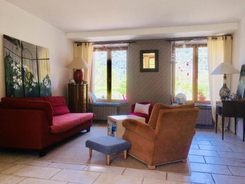 a living room with couches and chairs and a table at Ferme de la Cochette in Montcel