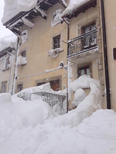 a pile of snow next to a building at Il Peschio in Pescocostanzo