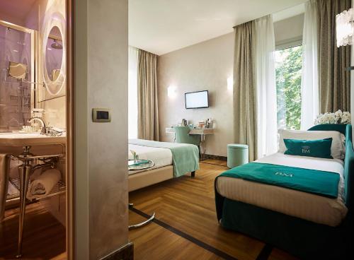 a hotel room with two beds and a sink at Bianca Maria Palace Hotel in Milan