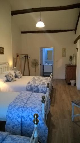 a bedroom with two beds and a hallway with a sink at 'La Maison Catalpa' French Farmhouse with Pool & Jaccuzi in Saint-Privat-des-Prés