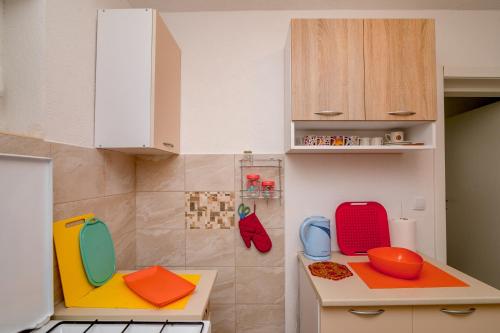 a kitchen with colorful dishes on the counters at Apartments Mitrovic in Lustica