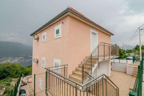 a house with stairs on the side of it at Apartments Mitrovic in Lustica
