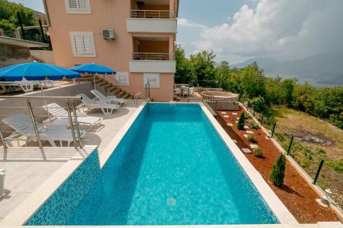 an image of a swimming pool at a villa at Apartments Mitrovic in Lustica