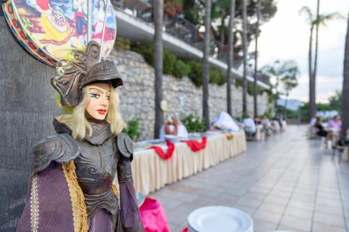 a figurine of a woman wearing a helmet on a wall at Hotel Ariston and Palazzo Santa Caterina in Taormina