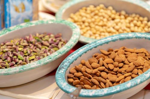 three bowls of nuts and seeds on a table at Hotel Ariston and Palazzo Santa Caterina in Taormina