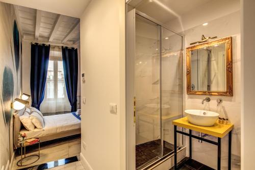 a bathroom with a sink and a glass shower at Little Queen Pantheon in Rome