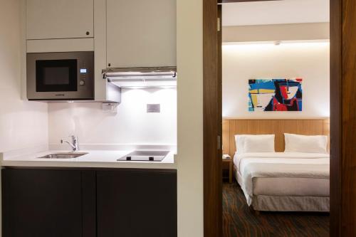 a kitchen with a sink and a bed in a room at Citea Apart Hotel in Beirut