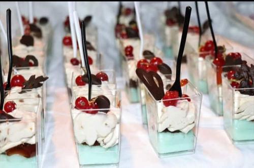 a row of glasses of desserts with cherries in them at Hotel Gioiella Depandance in Bellaria-Igea Marina