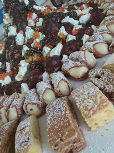 a bunch of different types of pastries on a table at Hotel Gioiella Depandance in Bellaria-Igea Marina