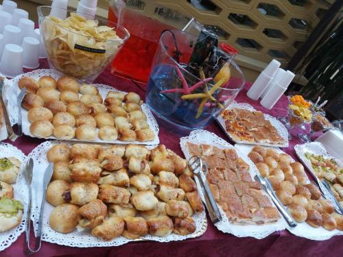 a table topped with plates of food and appetizers at Hotel Gioiella Depandance in Bellaria-Igea Marina