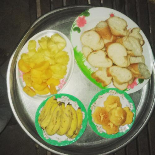 a table with four plates of fruit on it at Sok Phen Homestay in Siem Reap