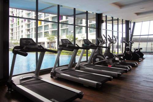 a row of cardio machines in a gym with a large window at Viva City Magamall Jazz 1 53 in Kuching