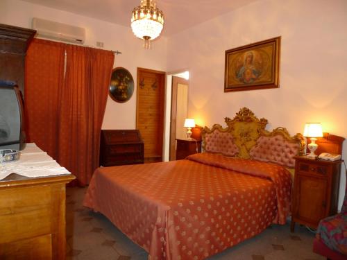 a bedroom with a bed and a tv in it at Hotel La Riva in Giardini Naxos