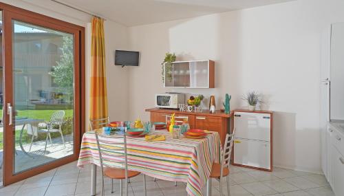 a kitchen with a table with a table cloth on it at Onda Blu Resort in Manerba del Garda