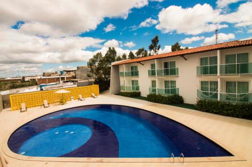 a large swimming pool in front of a building at Reserve Hotel in Surubim