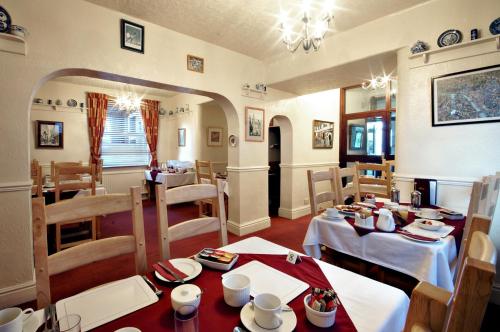 a dining room with two tables and chairs and a dining room at St Marys Guest House in York