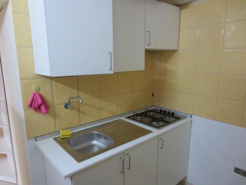 a small kitchen with a sink and a stove at Palona´s House in Espargos
