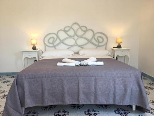 a bedroom with a bed with two towels on it at B&B Mediterraneo in Procida