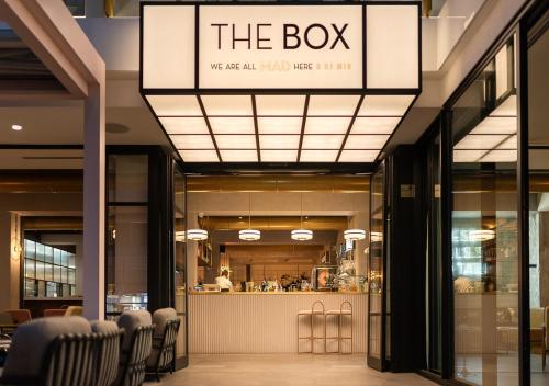 a restaurant with chairs and a bar in a building at The Box Riccione - Adults Only in Riccione