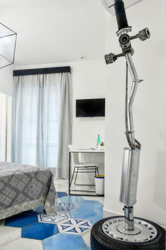 a room with a bed and a lamp on the floor at Big Rose in Rossano