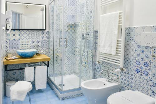 a bathroom with a shower and a toilet and a sink at Big Rose in Rossano