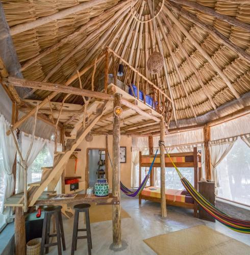 a room with a hammock in a hut at MELI-MELO P&B in Tulum