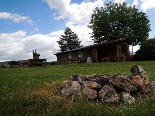 a pile of rocks in front of a cabin at Ferienwohnungen Hackl Ulrike in Mauth