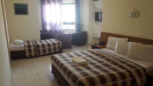 a hotel room with a bed and a couch at Razan Hotel in Amman