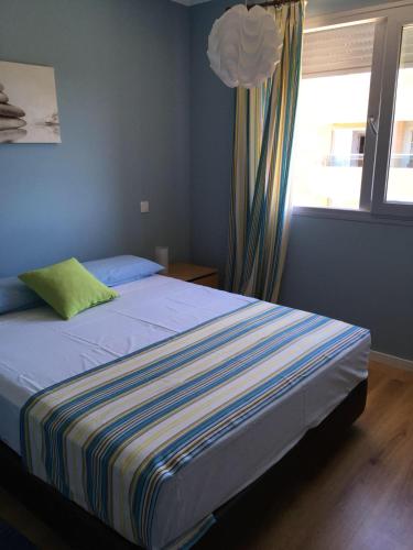 a bed in a room with a window and a bed sidx sidx sidx at Sea view - top floor in Quarteira