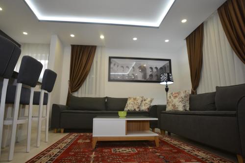 a living room with two couches and a table at Apart Hotel Family in Sarajevo